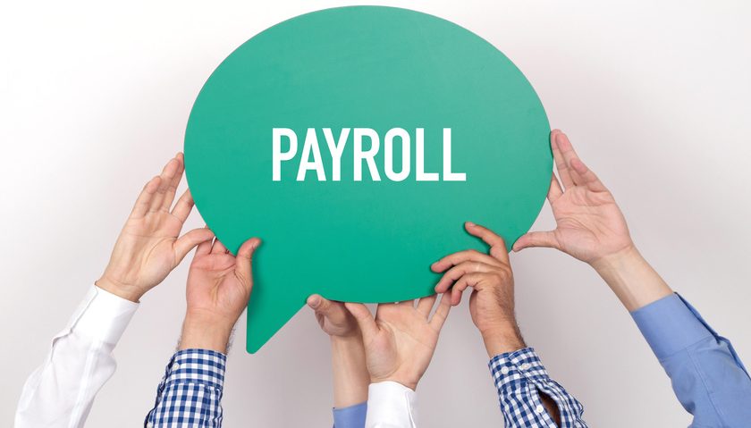 Group of people holding the PAYROLL written speech bubble